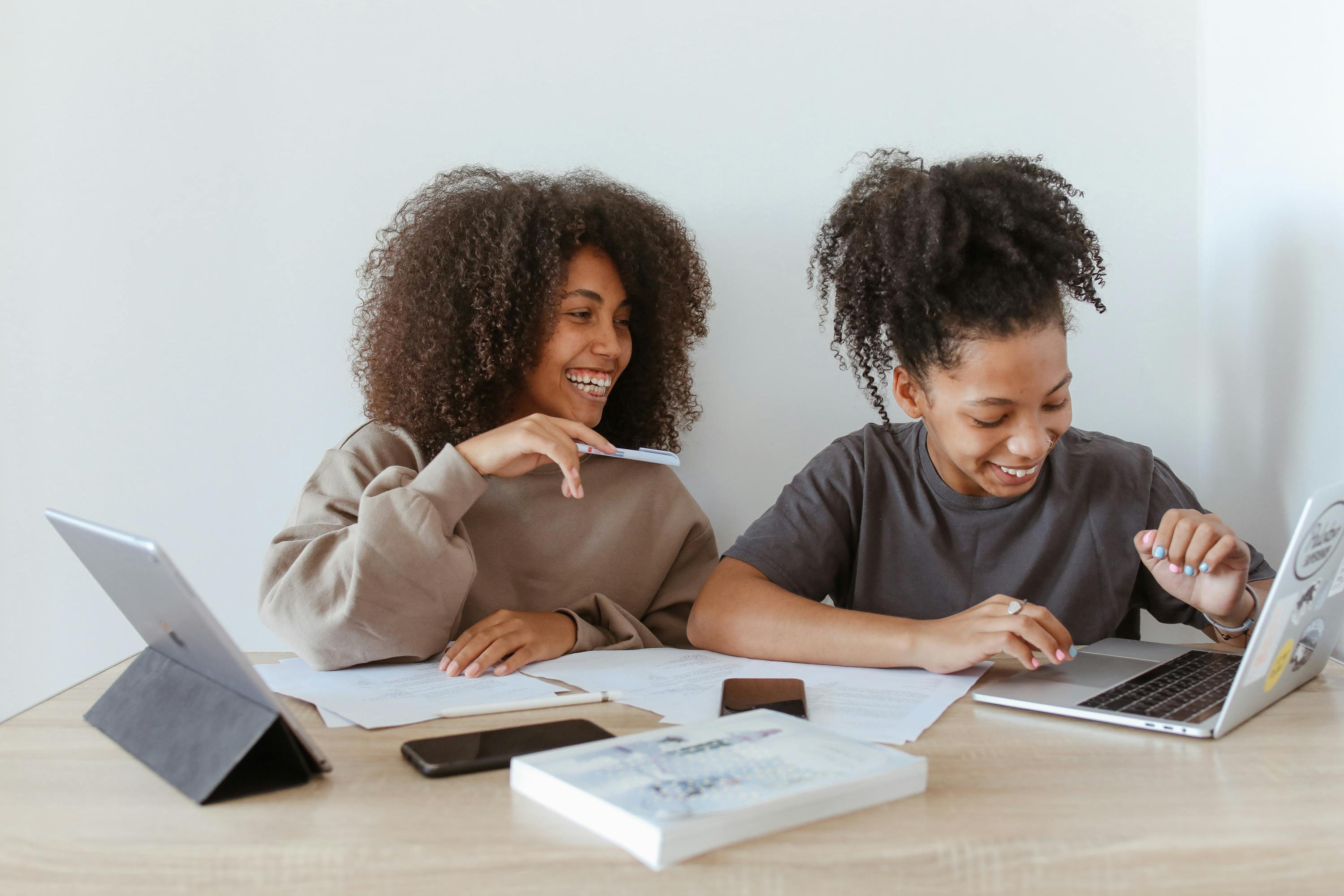 Young women working together on laptops